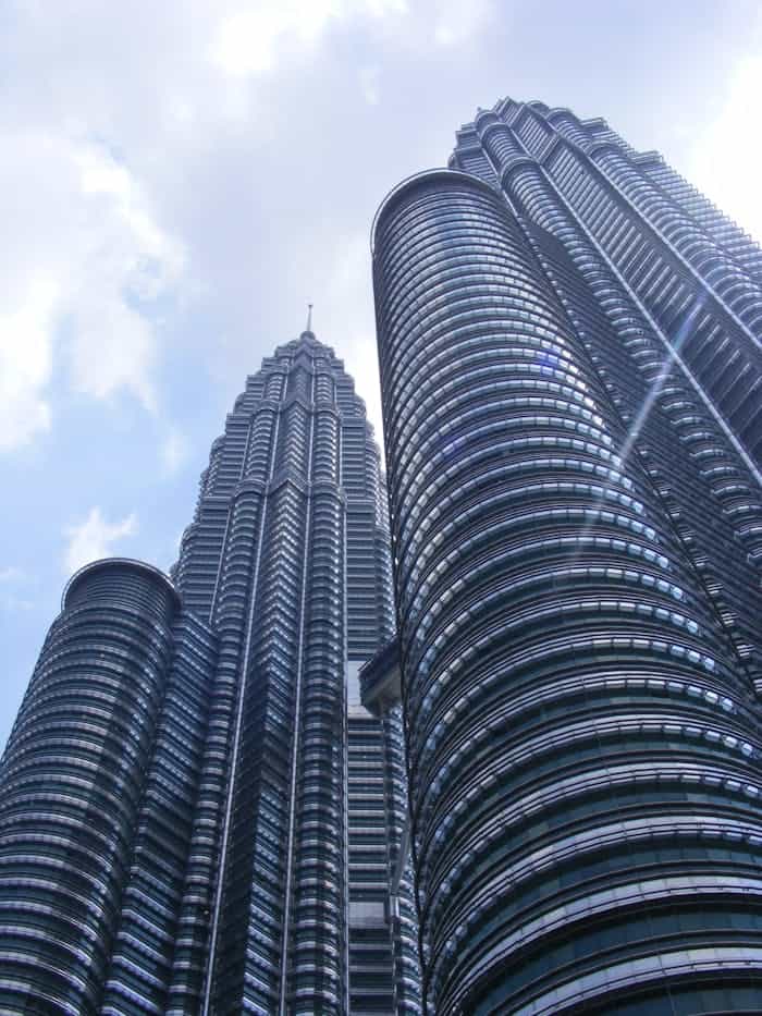 services-02 Majestic view of the iconic Petronas Twin Towers in Kuala Lumpur during daytime.